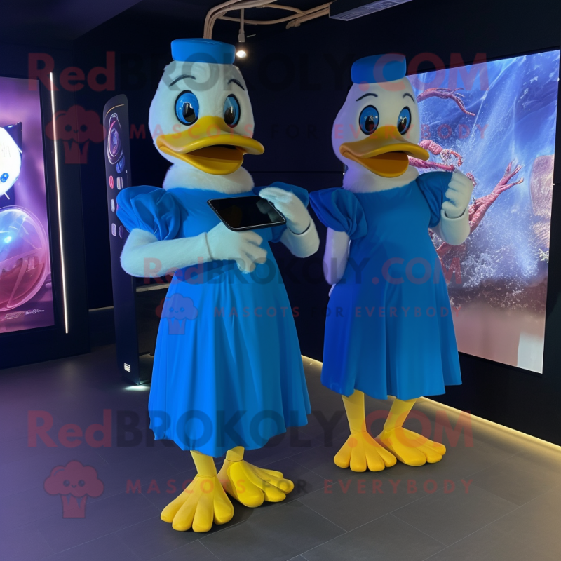Blue Duck mascot costume character dressed with a Maxi Dress and Smartwatches