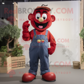 Red Apple mascot costume character dressed with a Dungarees and Gloves