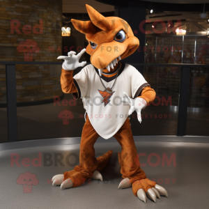 Rust Pterodactyl mascot costume character dressed with a Baseball Tee and Necklaces