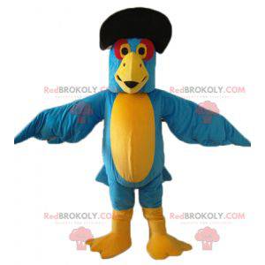 Mascotte de perroquet bleu et jaune avec un chapeau noir -