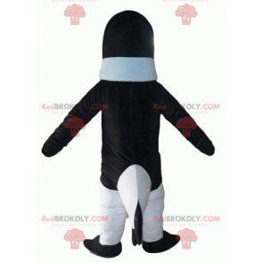 Black and white penguin mascot with a blue sweater -