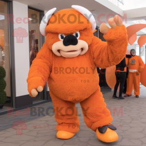Orange Bison mascot costume character dressed with a Jumpsuit and Mittens