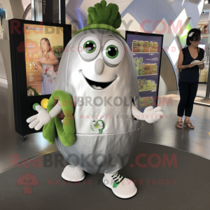 Silver Zucchini mascot costume character dressed with a Shorts and Coin purses