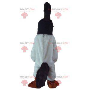 Zwart-witte vogel mascotte met een kuif op het hoofd -