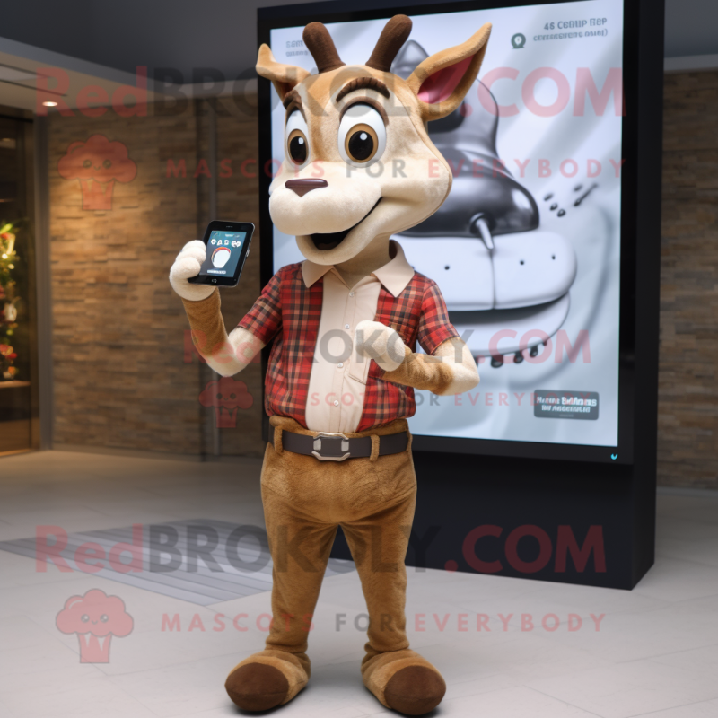 Beige Gazelle mascot costume character dressed with a Flannel Shirt and Smartwatches