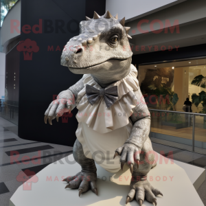 Silver Iguanodon mascot costume character dressed with a Mini Dress and Bow ties