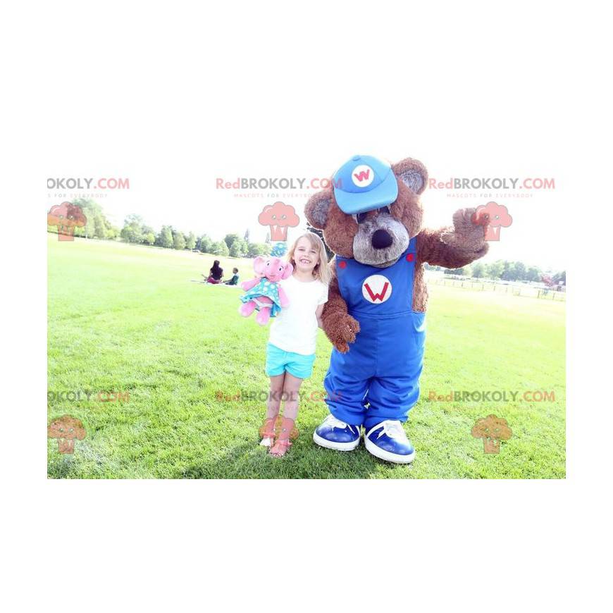 Mascota del oso de peluche marrón con un mono azul -