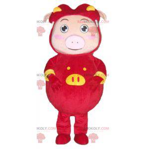 Pink pig mascot dressed in a red and yellow costume -