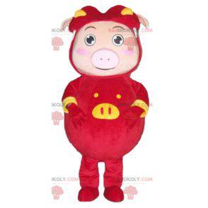 Pink pig mascot dressed in a red and yellow costume -