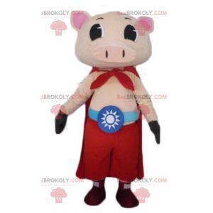 Mascotte de cochon rose avec un pantalon et une cape -