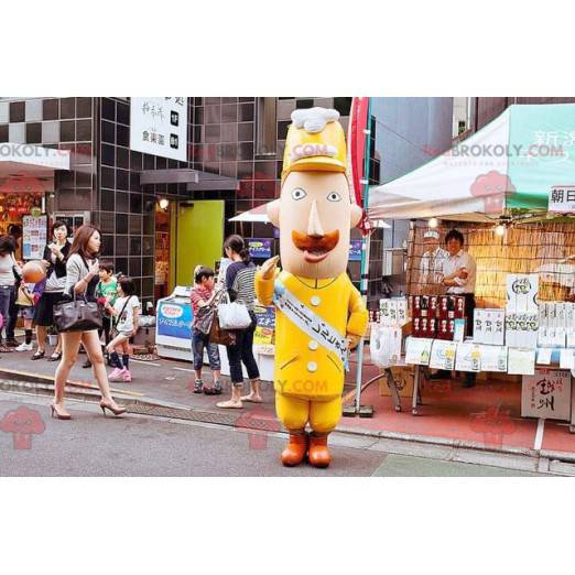 Mustached man mascotte in geel uniform - Redbrokoly.com