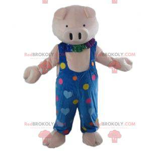 Mascotte maiale rosa in tuta blu con cuori colorati -