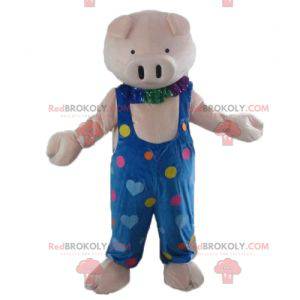 Pink pig mascot in blue overalls with colored hearts -