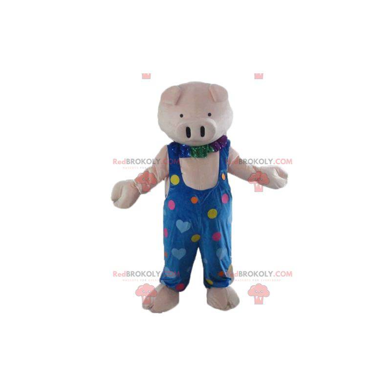 Mascota de cerdo rosa con un mono azul con corazones de colores Mascota de cerdo rosa con un mono azul con corazones de colores