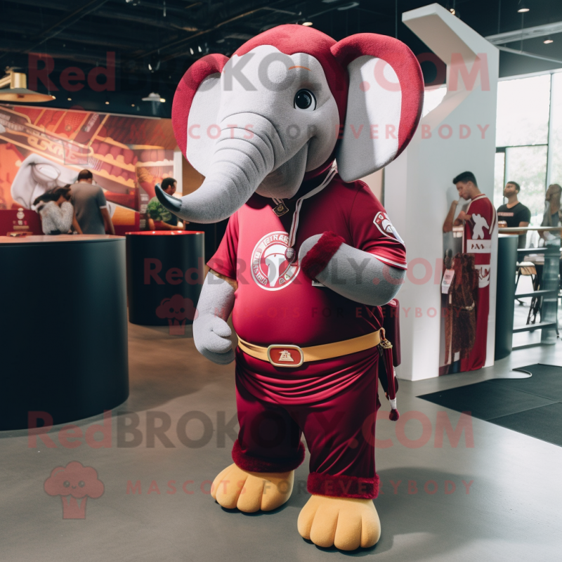 Maroon Elephant mascot costume character dressed with a Polo Tee and Bracelets Maroon Elephant mascot costume character dressed with a Polo Tee and Bracelets