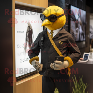 Gold Blackbird mascot costume character dressed with a Oxford Shirt and Smartwatches