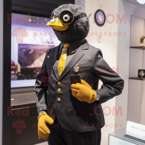 Gold Blackbird mascot costume character dressed with a Oxford Shirt and Smartwatches