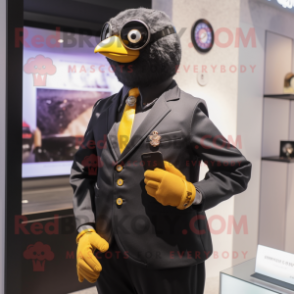 Gold Blackbird mascot costume character dressed with a Oxford Shirt and Smartwatches