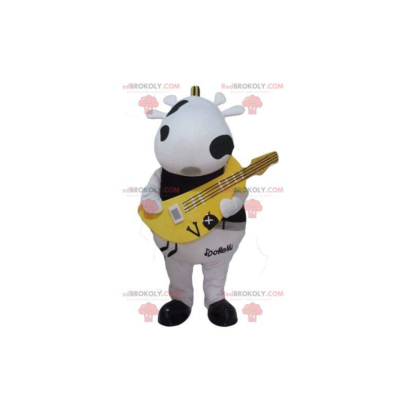 Mascote de vaca preto e branco com uma guitarra amarela -