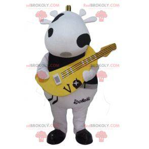 Mascote de vaca preto e branco com uma guitarra amarela -
