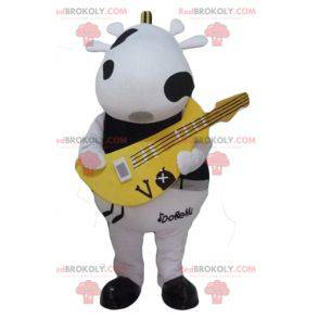 Mascotte de vache noire et blanche avec une guitare jaune -