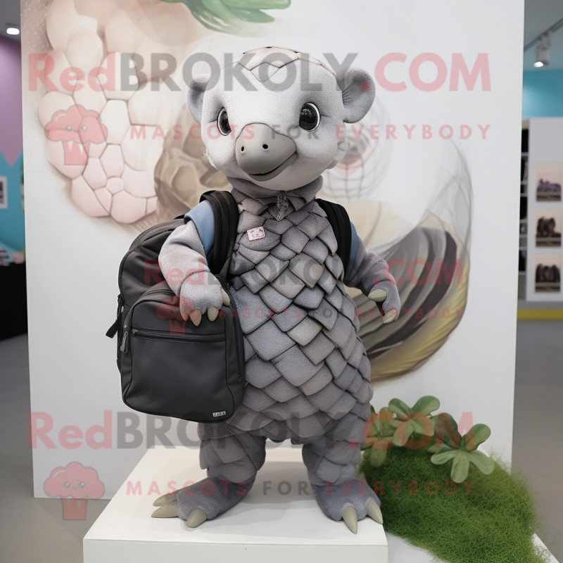 Gray Pangolin mascot costume character dressed with a Blouse and Messenger bags