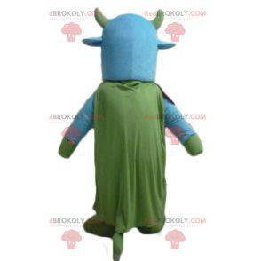 Mascote da vaca azul e verde com um sino no pescoço -