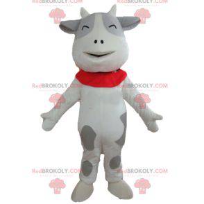 Mascota de vaca blanca y gris alegre y conmovedora -