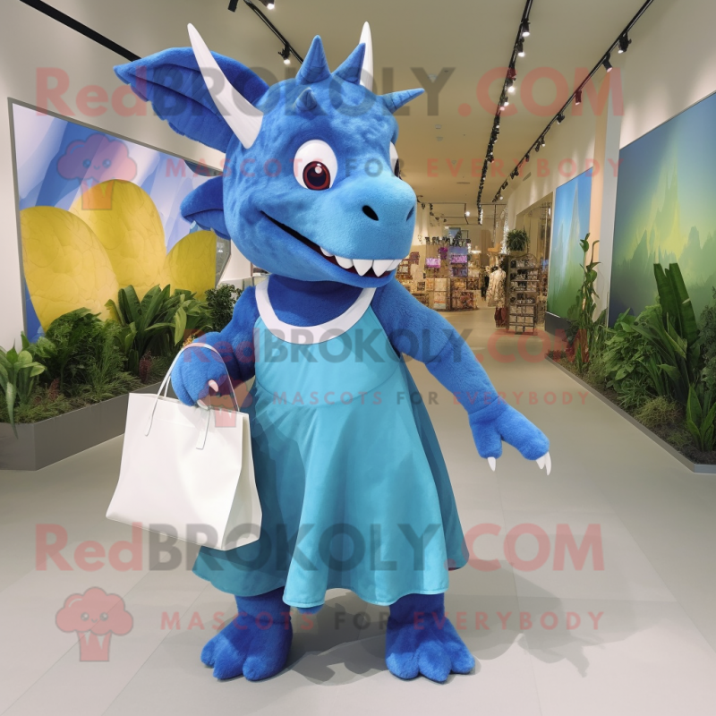 Blue Triceratops mascot costume character dressed with a Maxi Skirt and Tote bags Blue Triceratops mascot costume character dressed with a Maxi Skirt and Tote bags