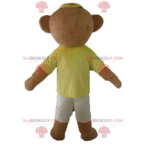 Brown teddy bear mascot in colorful outfit with glasses -