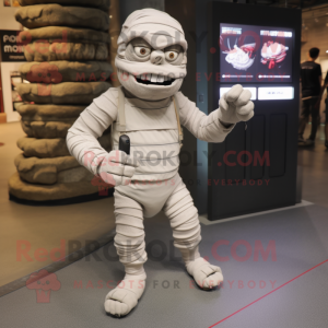 Gray Mummy mascot costume character dressed with a Cargo Shorts and Smartwatches