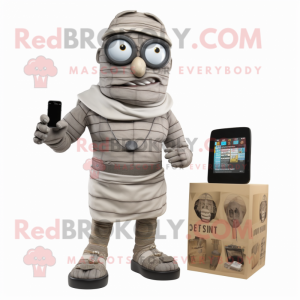 Gray Mummy mascot costume character dressed with a Cargo Shorts and Smartwatches