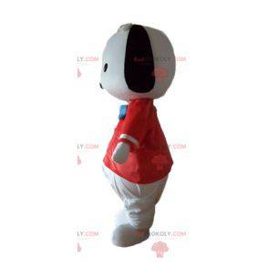 Kleines Schwarzweiss-Hundemaskottchen mit einem roten T-Shirt -