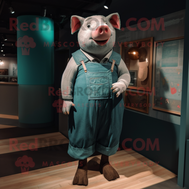 Teal Pig mascot costume character dressed with a Dungarees and Shawl pins Teal Pig mascot costume character dressed with a Dungarees and Shawl pins