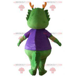 Green dinosaur mascot dressed in very warm purple -