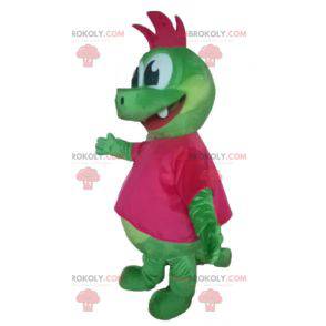 Mascota dragón dinosaurio verde con una cresta rosa -