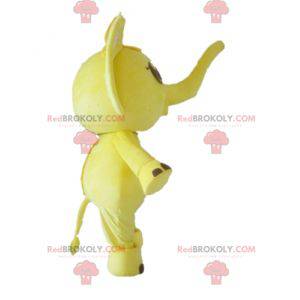 Mascote elefante amarelo e branco com um arco na cabeça -