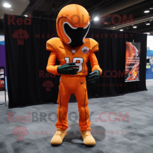 Orange American Football Helmet mascot costume character dressed with a Long Sleeve Tee and Shawl pins