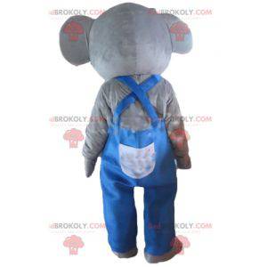 Grijze en roze olifant mascotte met blauwe overall -