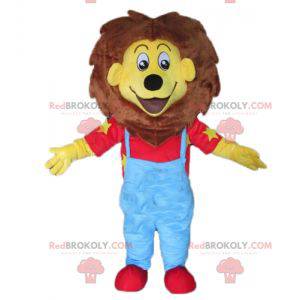 Mascot pequeño león amarillo y marrón en traje azul y rojo -