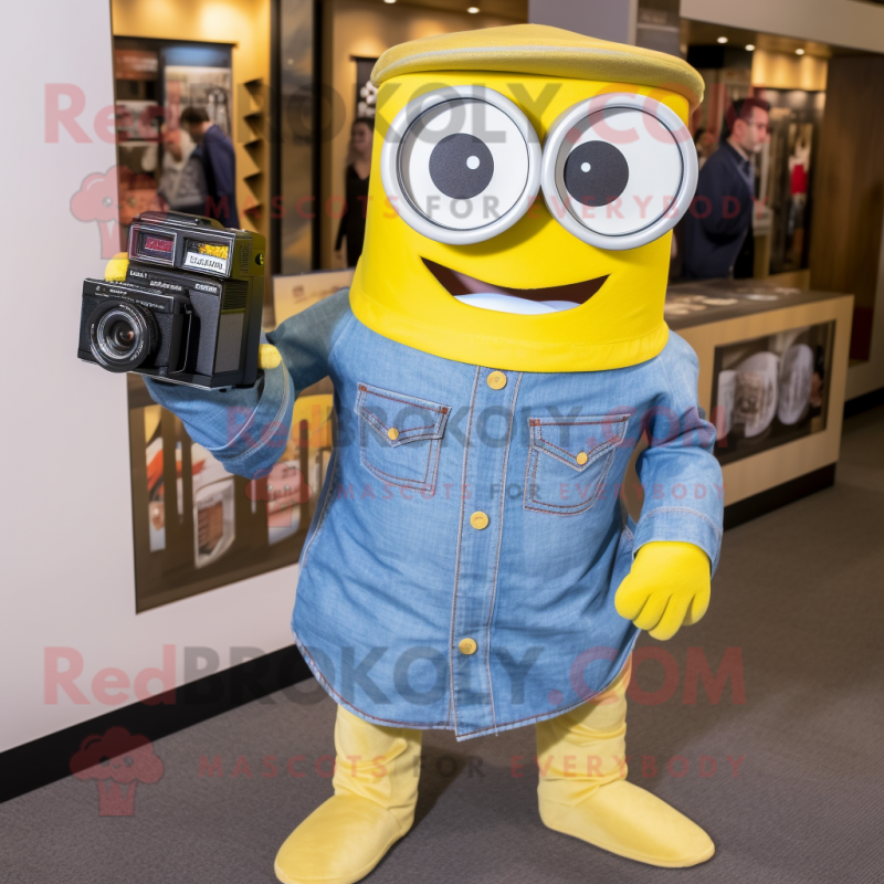 Yellow Camera mascot costume character dressed with a Chambray Shirt and Earrings