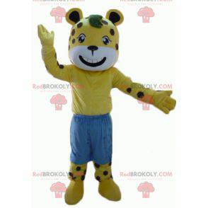 Mascotte de tigre jaune et blanc à pois marron avec un short -
