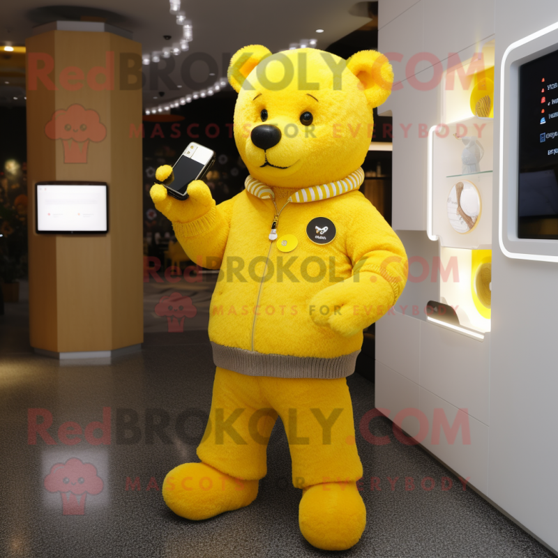 Yellow Bear mascot costume character dressed with a Cardigan and Smartwatches Yellow Bear mascot costume character dressed with a Cardigan and Smartwatches