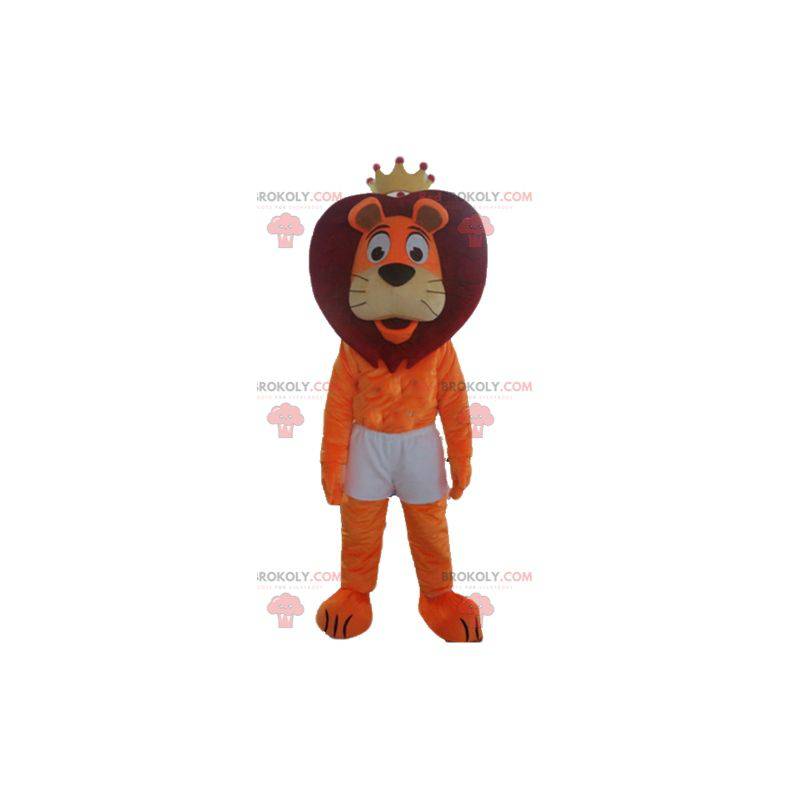 Orange och röd lejonmaskot i shorts med en krona -