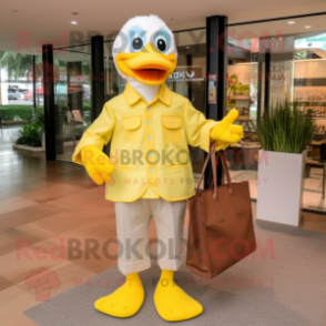 Lemon Yellow Duck mascot costume character dressed with a Dress Shirt and Tote bags