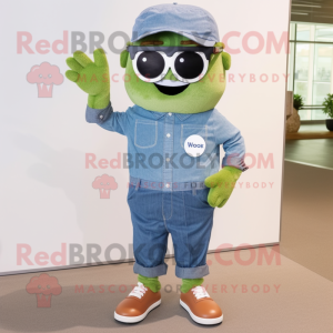 Olive Cupcake mascot costume character dressed with a Chambray Shirt and Sunglasses