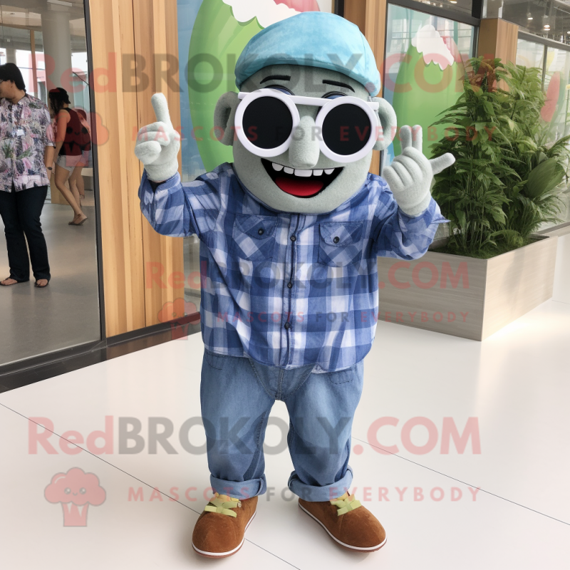 Olive Cupcake mascot costume character dressed with a Chambray Shirt and Sunglasses