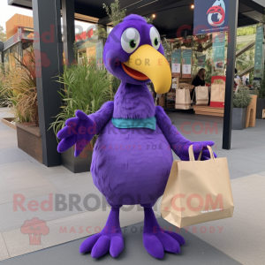 Purple Dodo Bird mascot costume character dressed with a Long Sleeve Tee and Tote bags