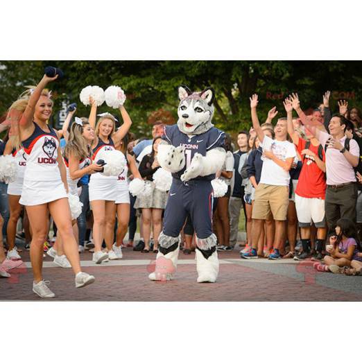 Mascotte del husky del cane lupo in abbigliamento sportivo -