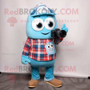 Sky Blue Camera mascot costume character dressed with a Flannel Shirt and Scarves